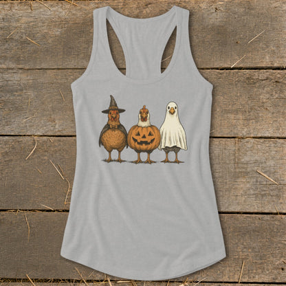 Three chickens dressed as a witch, pumpkin, and ghost on a grey tank top.