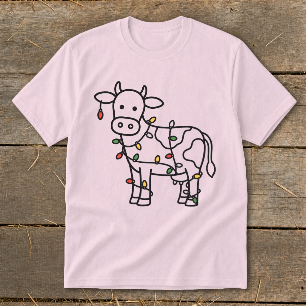 Light pink t-shirt with a black outline of a cow adorned with colorful Christmas lights.