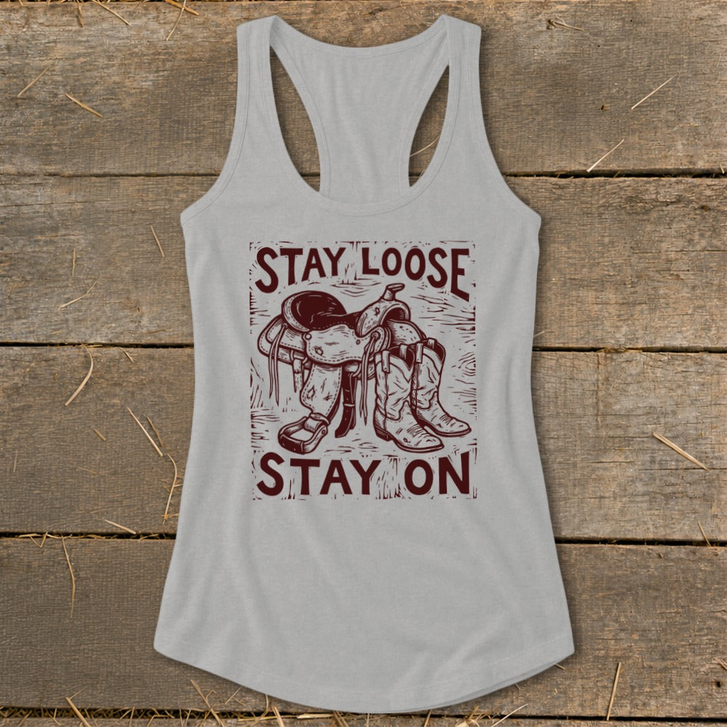 Tank top with "Stay Loose Stay On" text, saddle, and cowboy boots graphic.