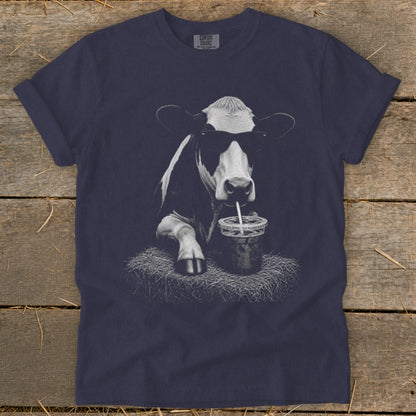 Dark blue t-shirt with a black and white graphic of a cow wearing sunglasses and drinking from a cup.