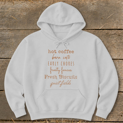 White hoodie with text "hot coffee barn cats EARLY CHORES frosty fences Fresh Biscuits quiet fields".