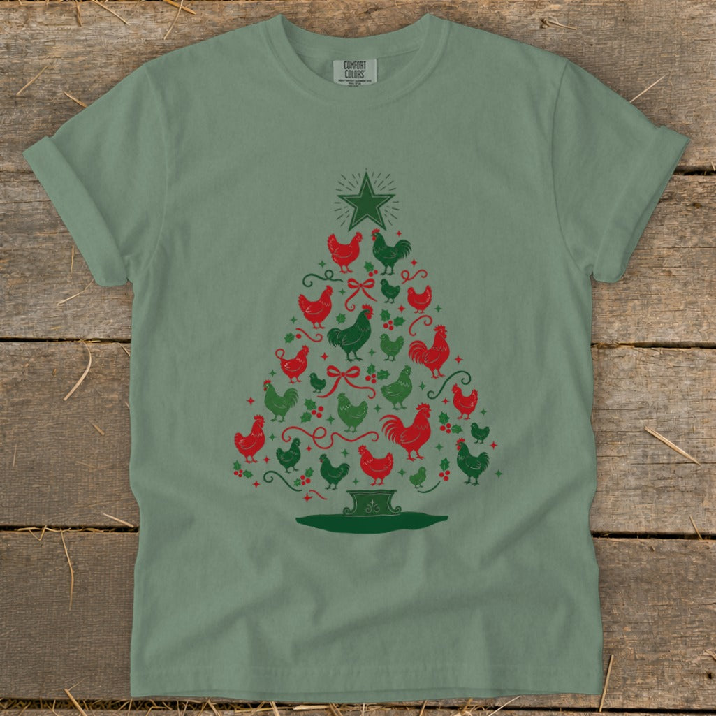 Green t-shirt with a Christmas tree made of red and green chickens and holly.