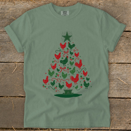Green t-shirt with a Christmas tree made of red and green chickens and holly.