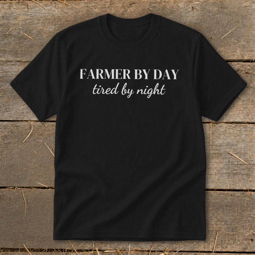 Black t-shirt with white text that reads "FARMER BY DAY tired by night".