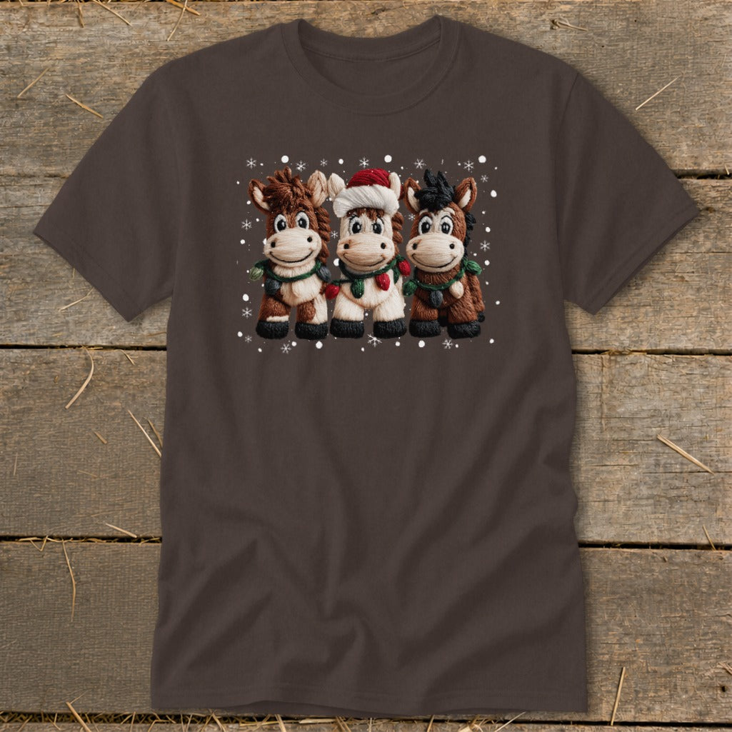 Three cartoon horses wearing festive lights and one with a Santa hat.