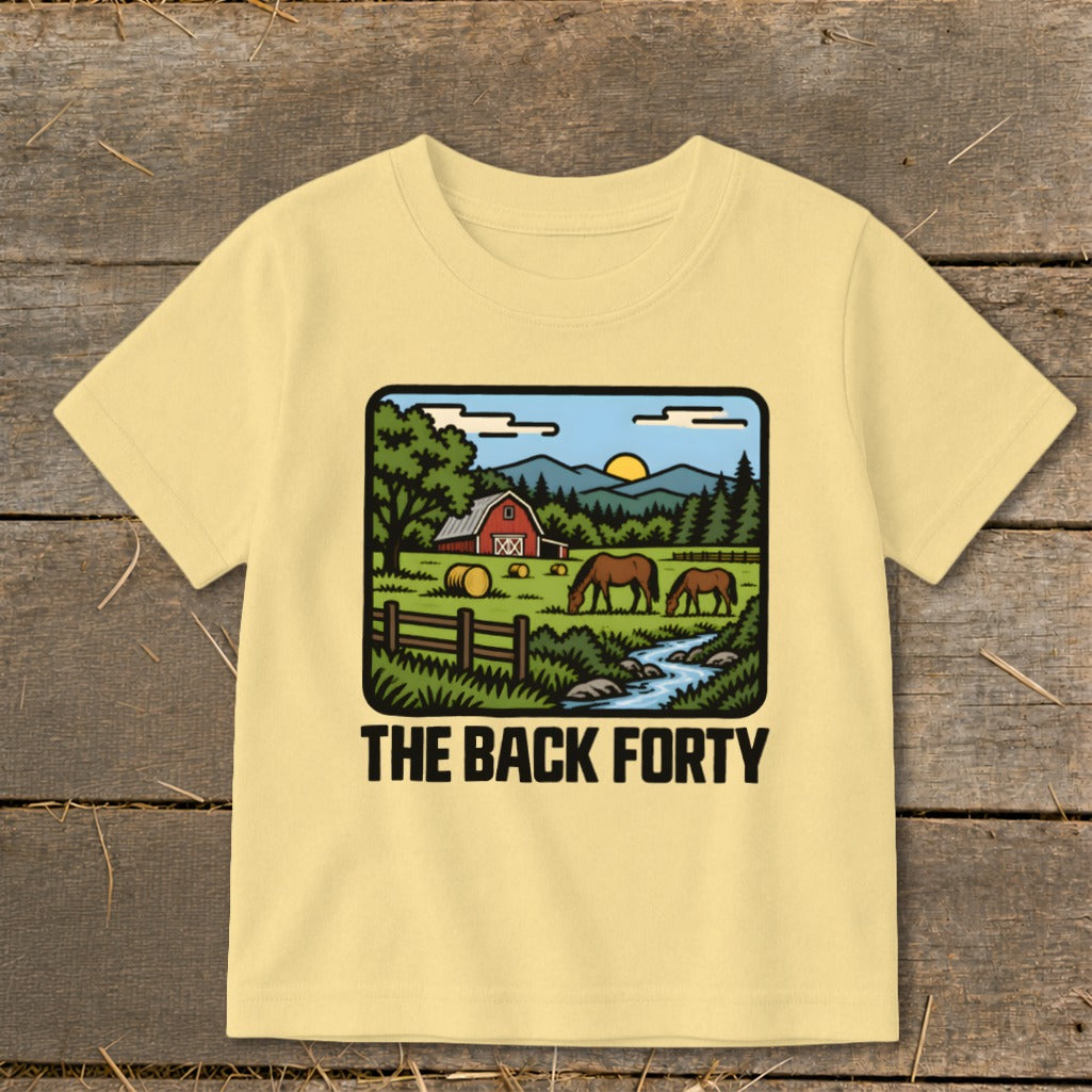 A light yellow children's t-shirt features a vintage rural farm illustration and the text The Back Forty.