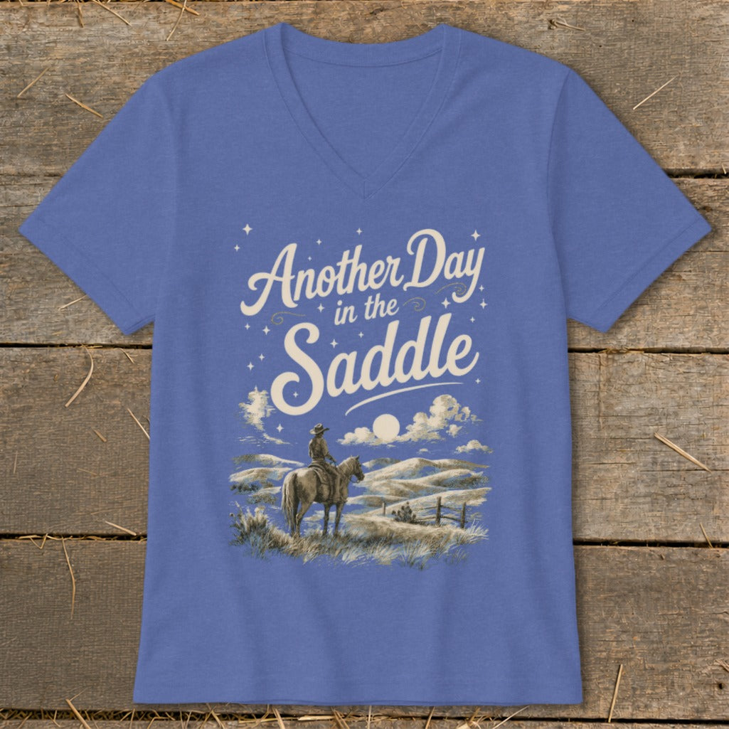 Blue t-shirt with "Another Day in the Saddle" text and cowboy on horseback graphic.