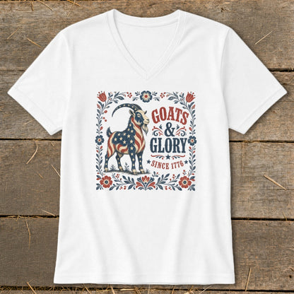 White v-neck t-shirt with "Goats & Glory Since 1776" and a patriotic goat graphic.