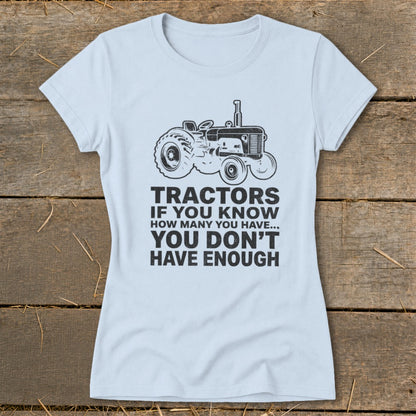Light blue t-shirt with a black tractor graphic and the text "Tractors if you know how many you have... you don't have enough."