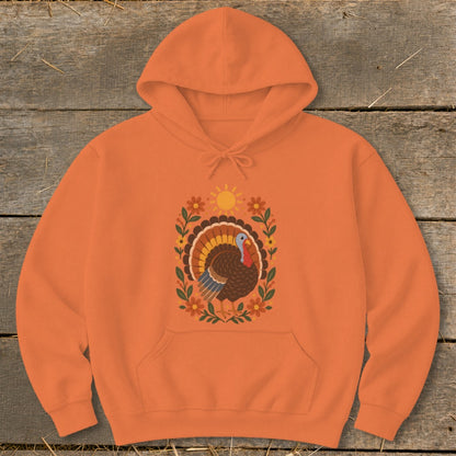Orange hoodie with a colorful turkey and floral design.