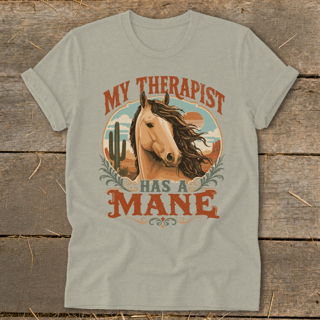 Light tan t-shirt with graphic of horse and text "My therapist has a mane".