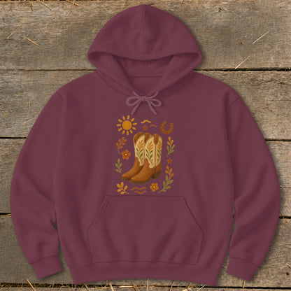 Maroon hoodie with cowboy boots, sun, horseshoe, and floral graphic.