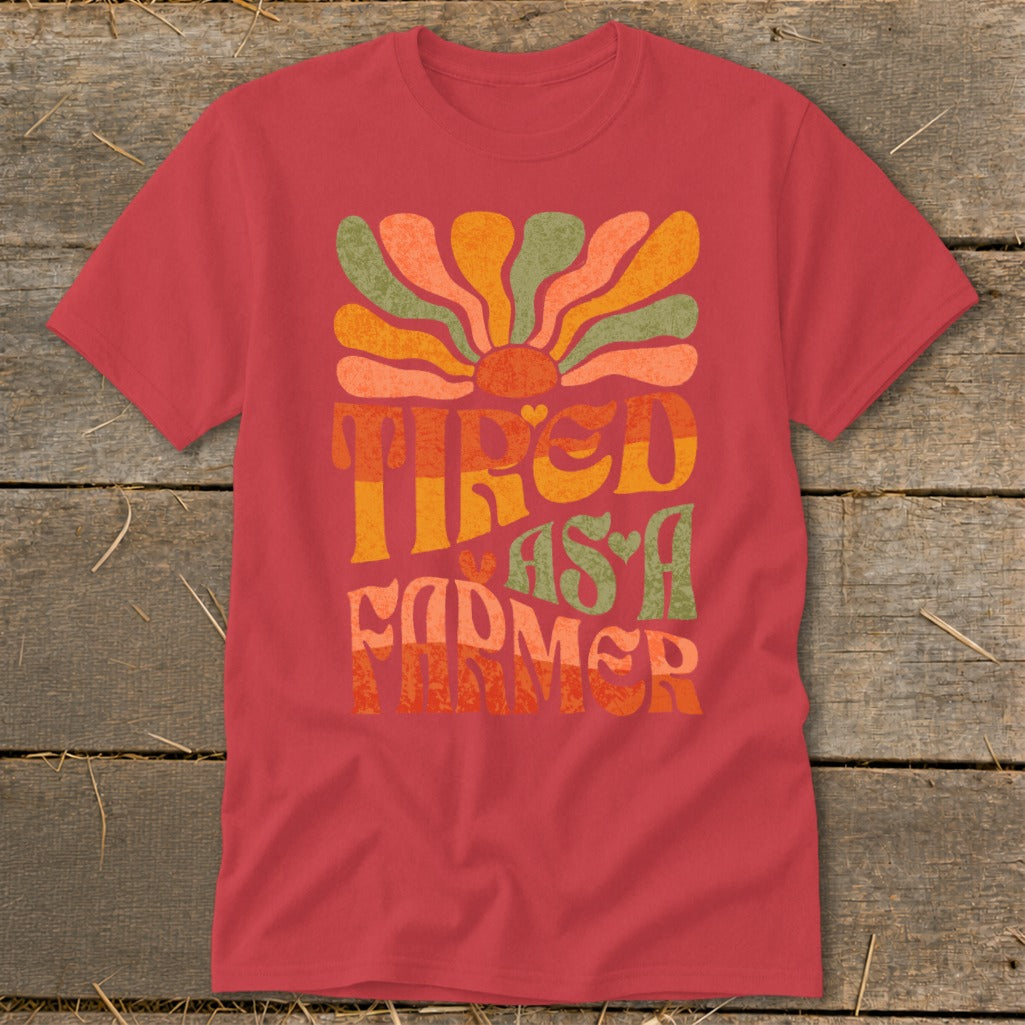Red t-shirt with "Tired as a Farmer" text and groovy sun design.