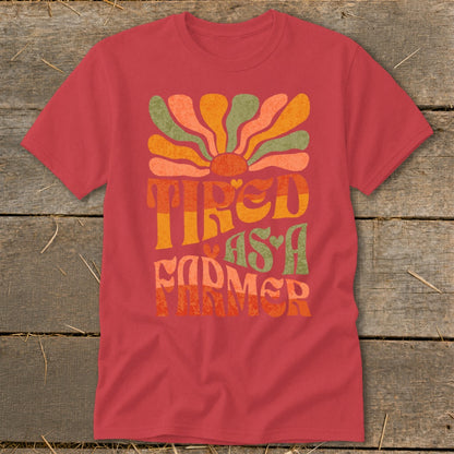 Red t-shirt with "Tired as a Farmer" text and groovy sun design.
