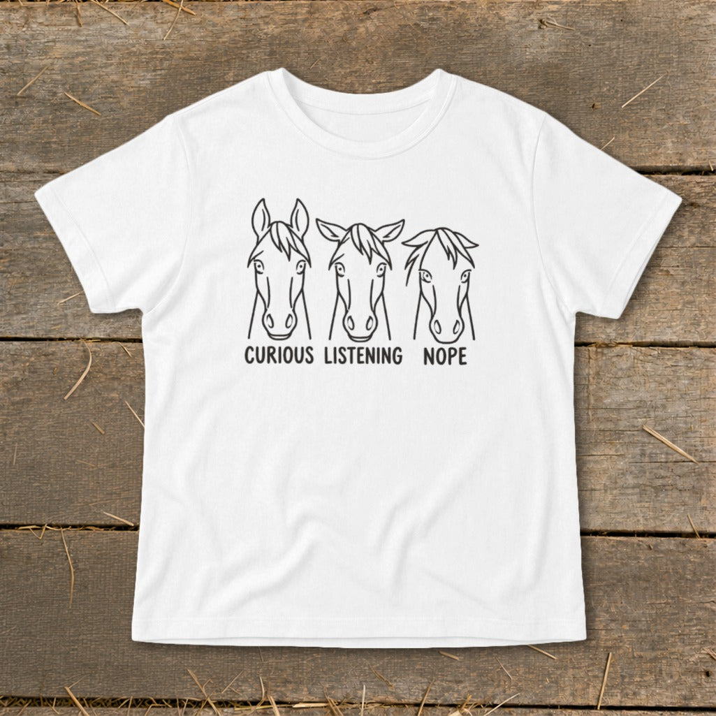 A white t-shirt featuring a black graphic of three horses with the text CURIOUS LISTENING NOPE.