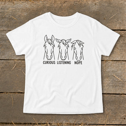 A white t-shirt featuring a black graphic of three horses with the text CURIOUS LISTENING NOPE.