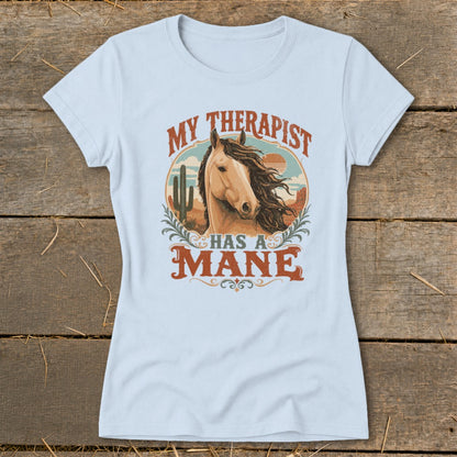 Light blue t-shirt with "My therapist has a mane" text and horse graphic.