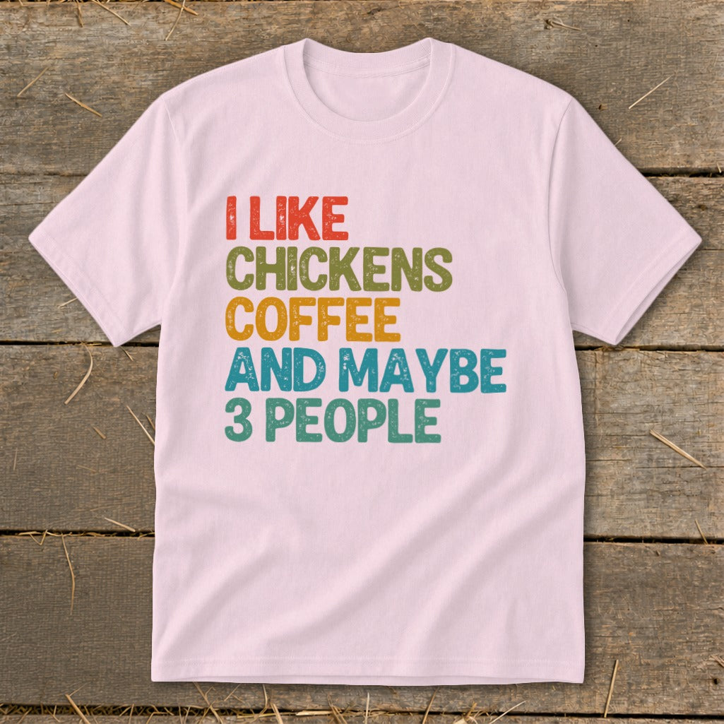 Light pink t-shirt with text "I LIKE CHICKENS COFFEE AND MAYBE 3 PEOPLE".