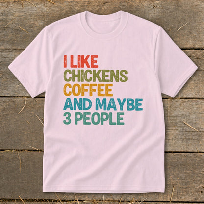 Light pink t-shirt with text "I LIKE CHICKENS COFFEE AND MAYBE 3 PEOPLE".