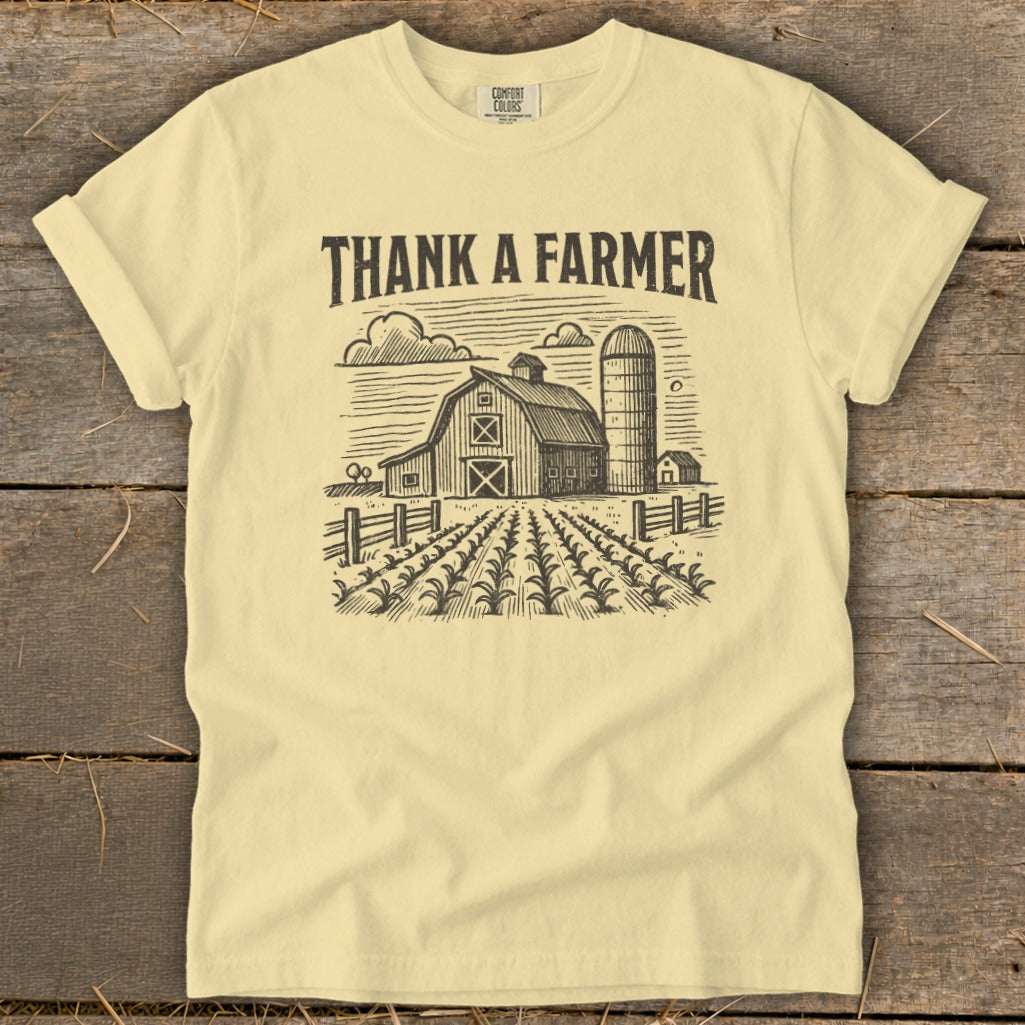 Light yellow t-shirt with "THANK A FARMER" text over a farm scene.
