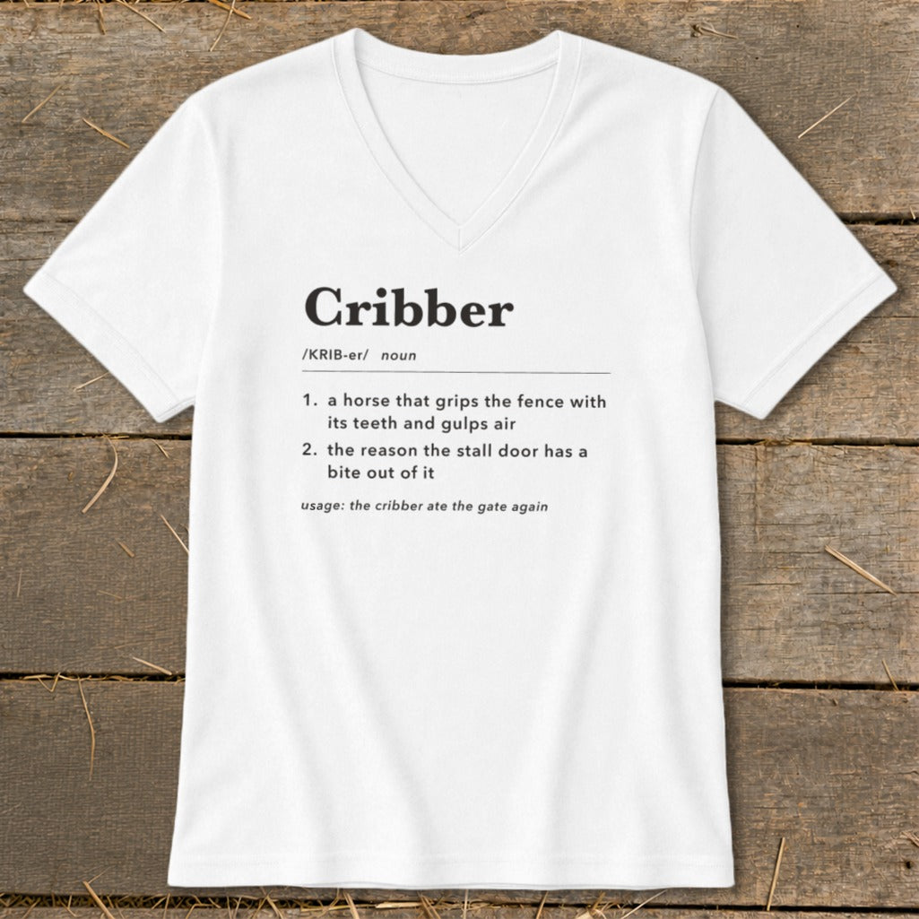 A white V-neck t-shirt featuring a dictionary definition of the word Cribber printed on the front.