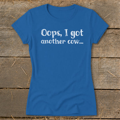Blue t-shirt with white text that says "Oops, I got another cow..."