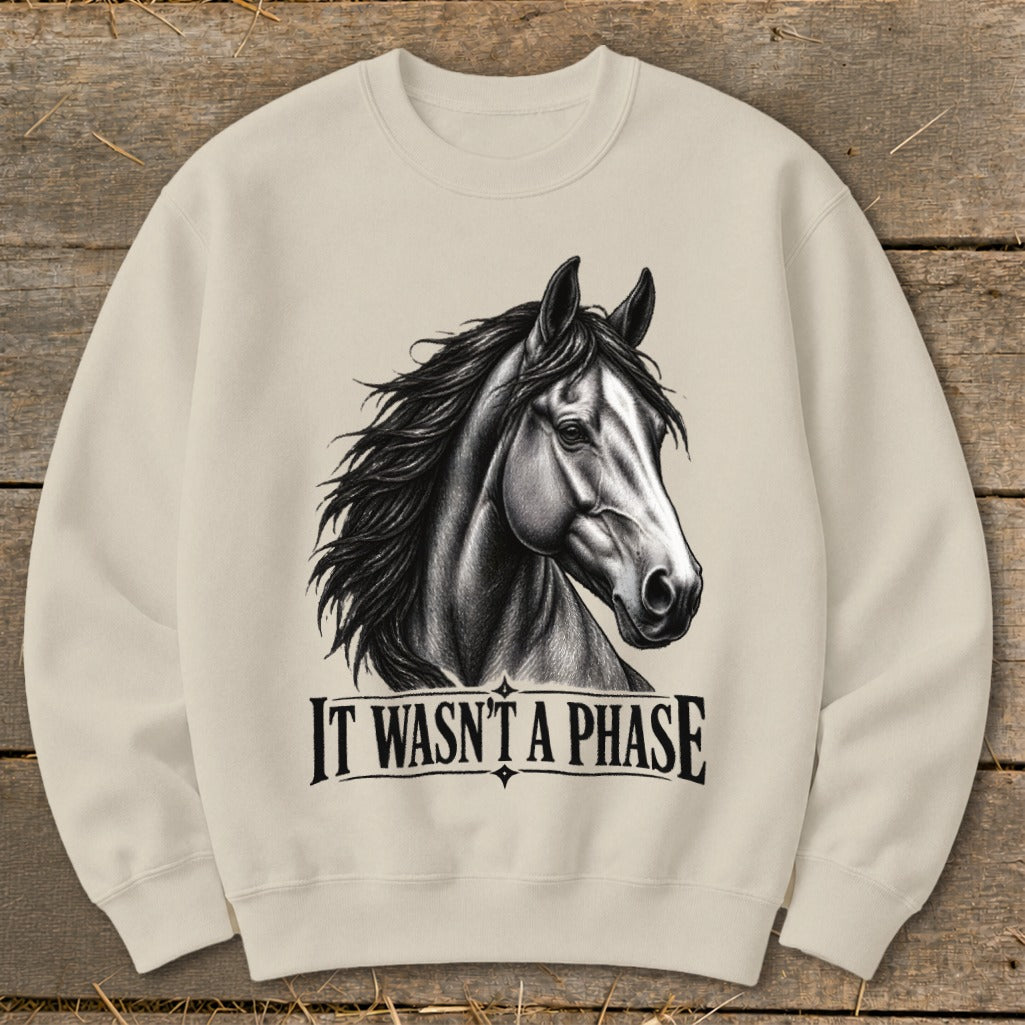 Light beige crewneck sweatshirt with a black and white horse illustration and text "IT WASN'T A PHASE."