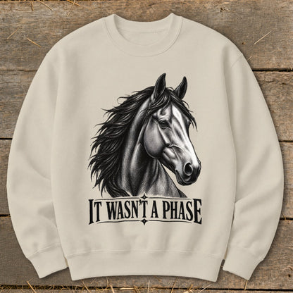 Light beige crewneck sweatshirt with a black and white horse illustration and text "IT WASN'T A PHASE."