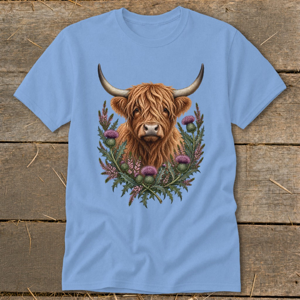 Light blue t-shirt with a Highland cow and thistles graphic design.