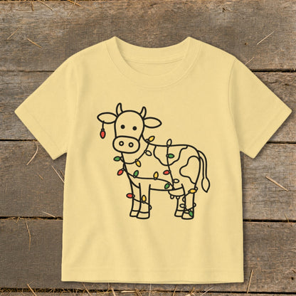 Light yellow t-shirt with a black line drawing of a cow wrapped in colorful Christmas lights.