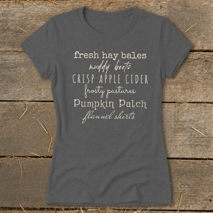 Gray t-shirt with "fresh hay bales, muddy boots, CRISP APPLE CIDER, frosty pastures, Pumpkin Patch, flannel shirts" text.