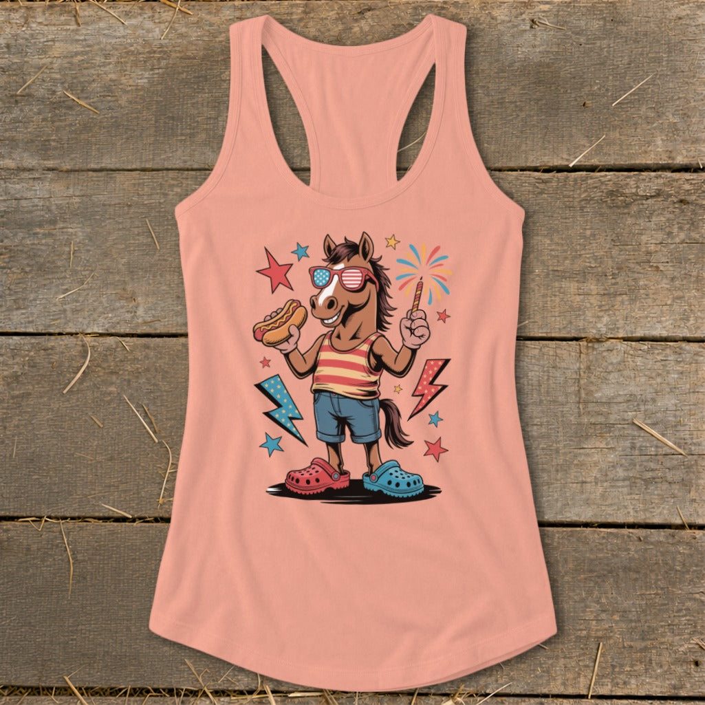 Cartoon horse wearing American flag sunglasses, holding hot dog and sparkler on peach tank top.