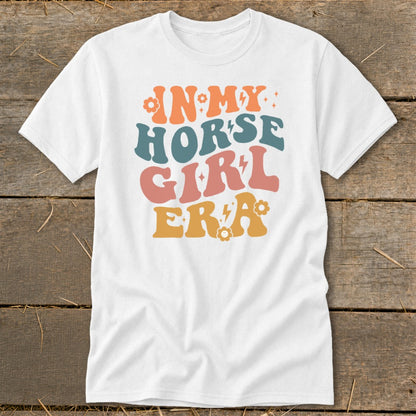 White t-shirt with retro graphic text "IN MY HORSE GIRL ERA".