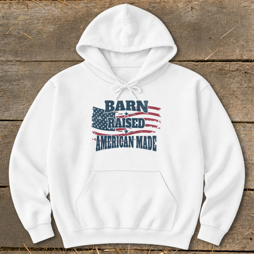 White hoodie with "Barn Raised American Made" text and distressed American flag graphic.