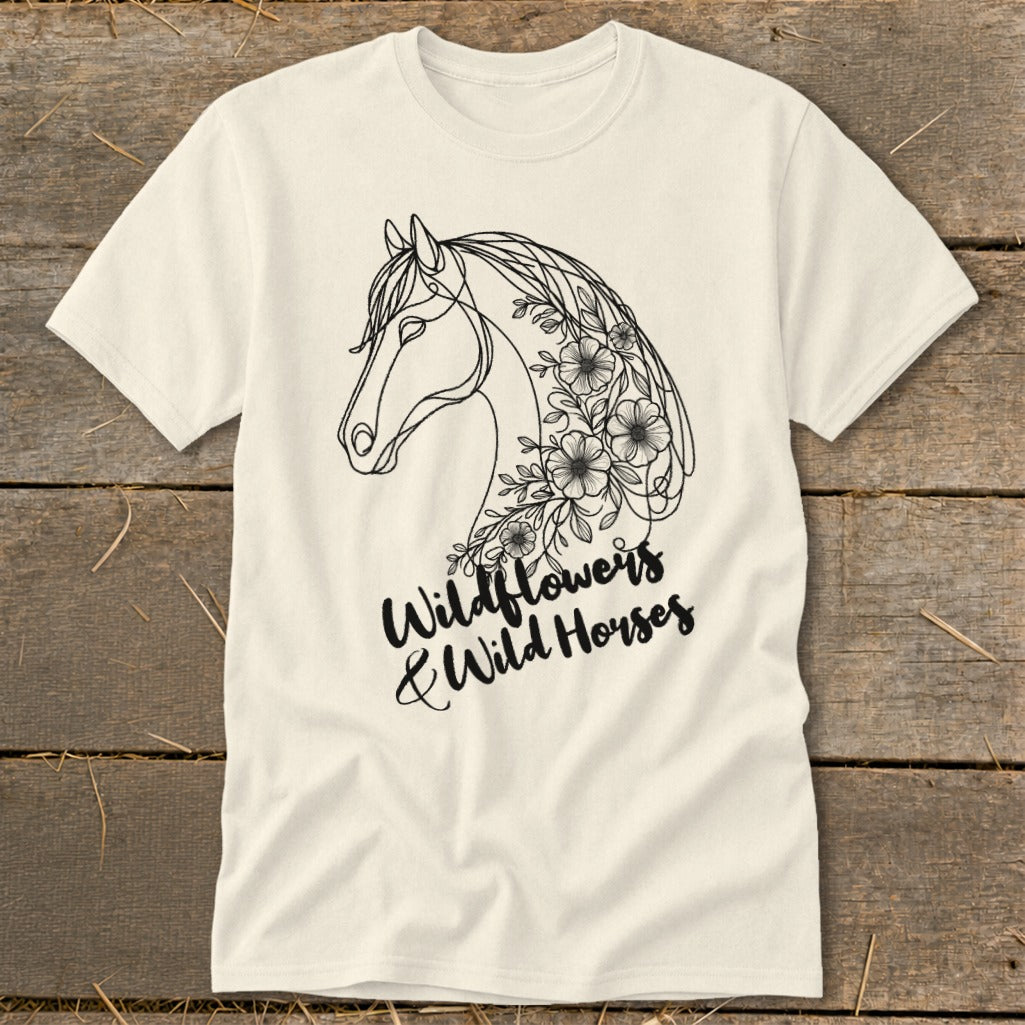 Cream t-shirt with a black line drawing of a horse's head adorned with wildflowers. Text reads "Wildflowers & Wild Horses".