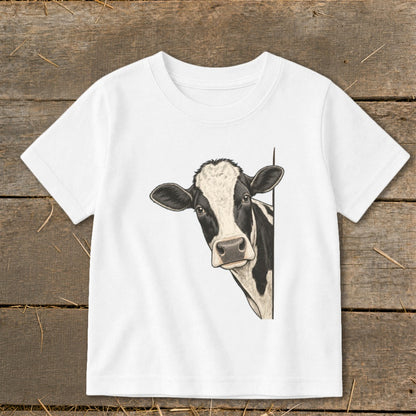 White t-shirt with a black and white cow peeking from the side.