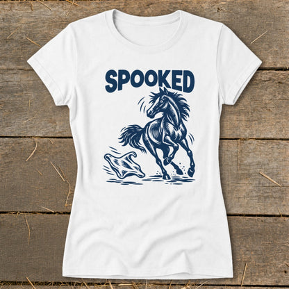 White t-shirt with dark blue "SPOOKED" text and a startled horse jumping over a ghost graphic.