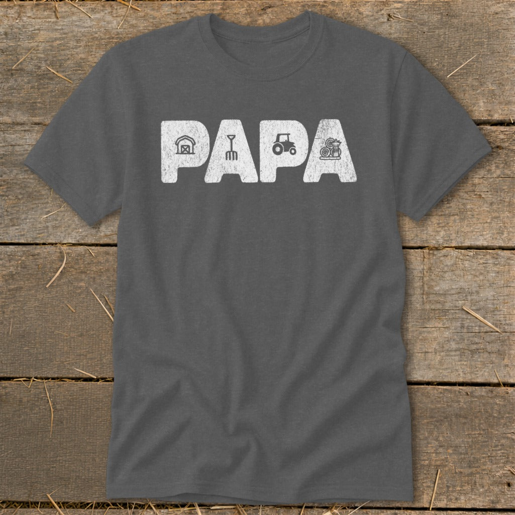 Dark gray t-shirt with "PAPA" text and farm icons: barn, rake, tractor, hay bale.