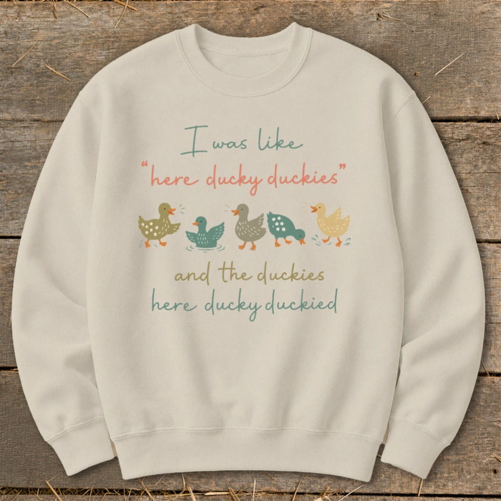 Light beige sweatshirt with text "I was like 'here ducky duckies' and the duckies here ducky duckied."