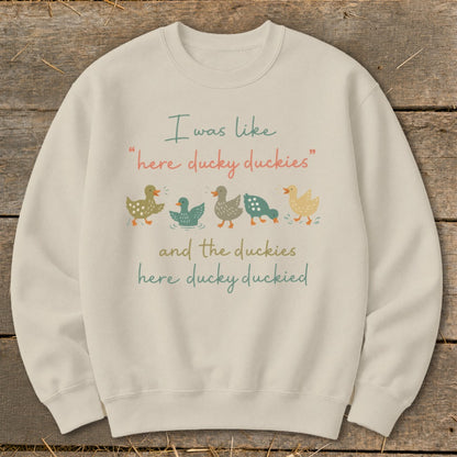 Light beige sweatshirt with text "I was like 'here ducky duckies' and the duckies here ducky duckied."