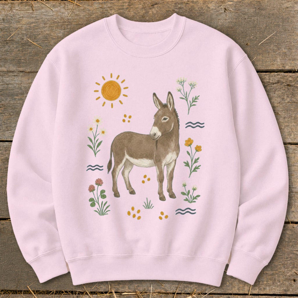 Pink sweatshirt with a brown donkey, sun, and floral illustrations.