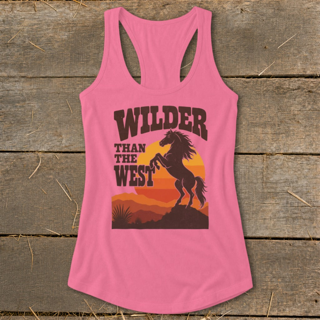 Pink tank top with "Wilder Than The West" text and a horse at sunset graphic.
