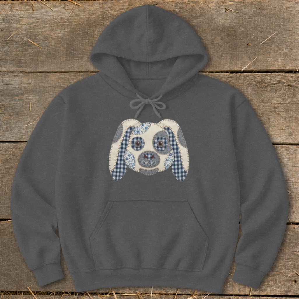 Dark gray hoodie with a patchwork puppy face applique on the chest.