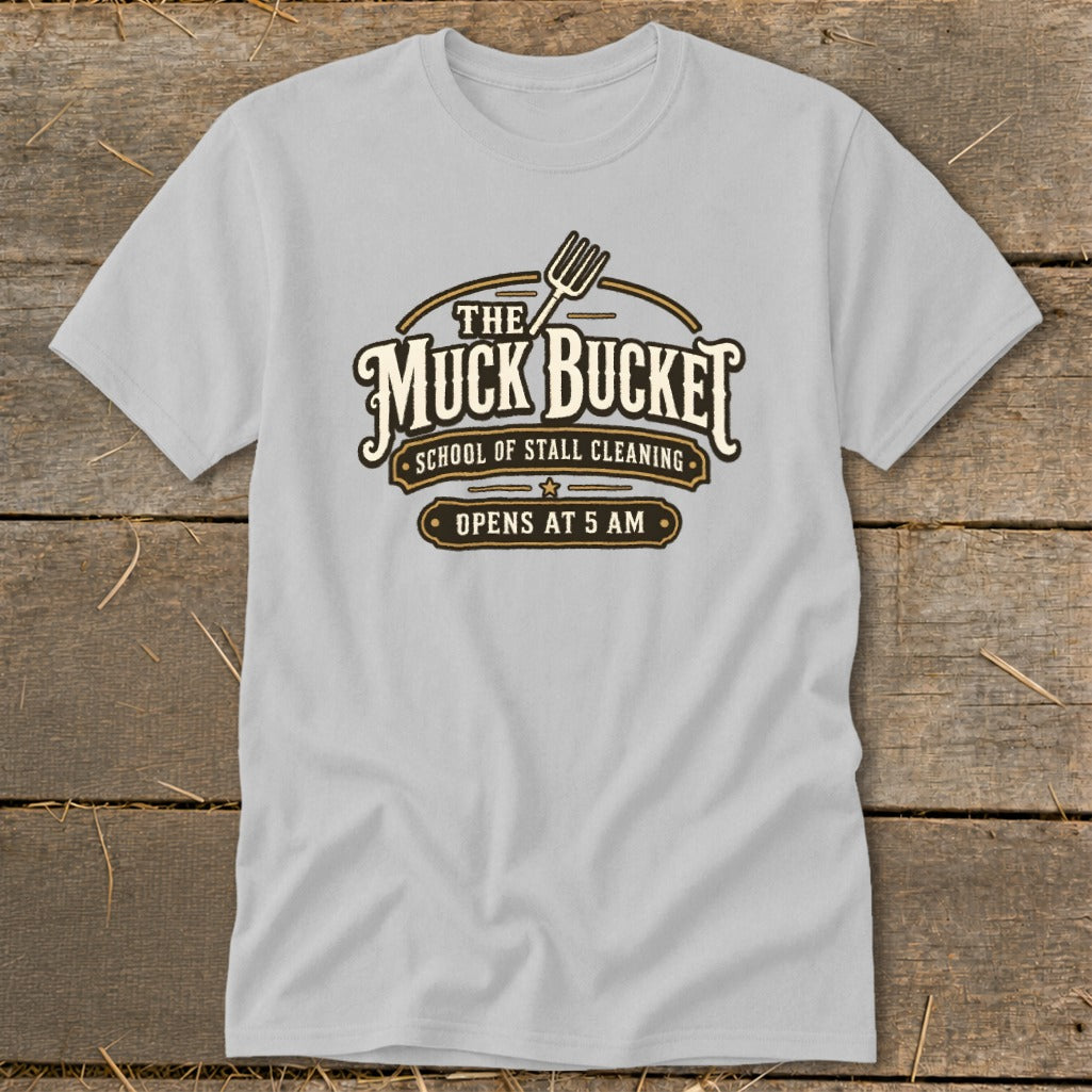 Light grey t-shirt with "The Muck Bucket School of Stall Cleaning" logo.