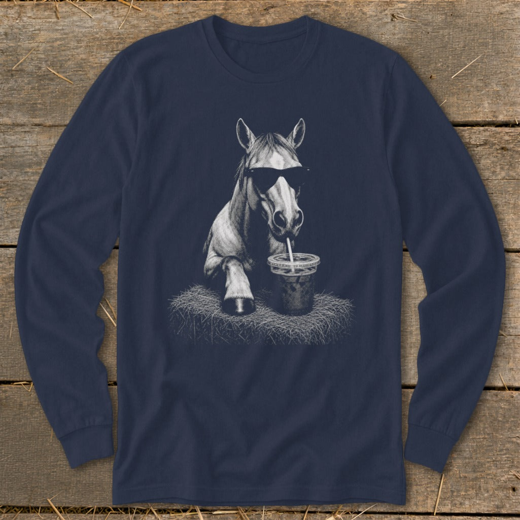 Horse wearing sunglasses drinks from a straw in a cup on a hay bale.
