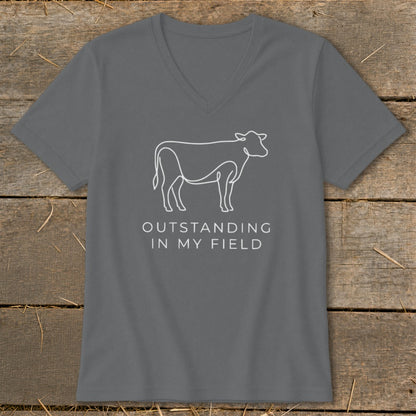 Gray v-neck t-shirt with white line drawing of a cow and text "OUTSTANDING IN MY FIELD".