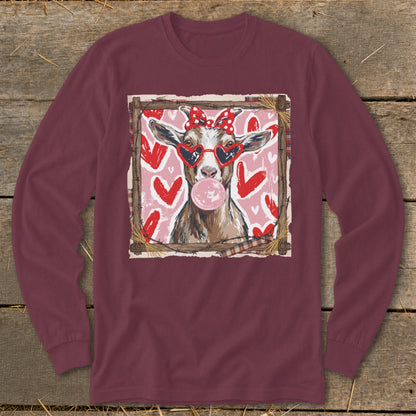 Goat wearing heart sunglasses and red bow blowing bubblegum, surrounded by hearts.