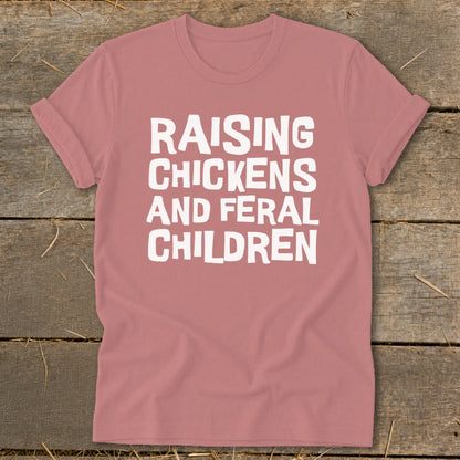Rose t-shirt with white text "RAISING CHICKENS AND FERAL CHILDREN".