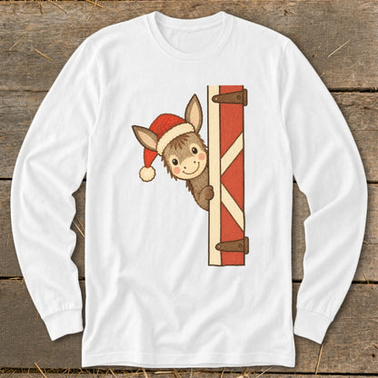 White long-sleeve shirt with a cartoon donkey wearing a Santa hat peeking from behind a barn door.