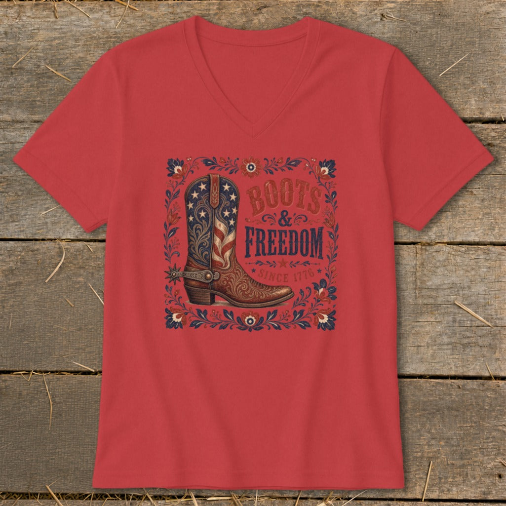 Red v-neck t-shirt with a cowboy boot featuring a U.S. flag design and "Boots & Freedom Since 1776" text.